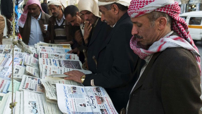 image showing men reading newspapers in yemen